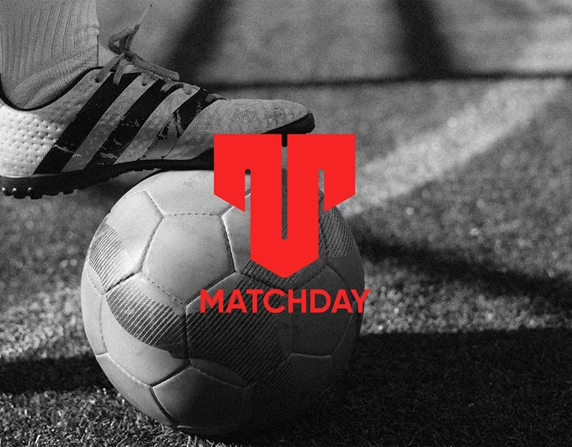 Matchday sports store branding with a red symbol over black-and-white football imagery