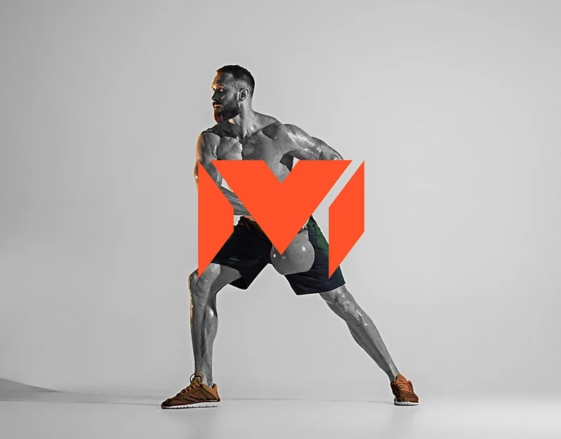 MV Fitness Academy's red monogram layered over an athlete in motion